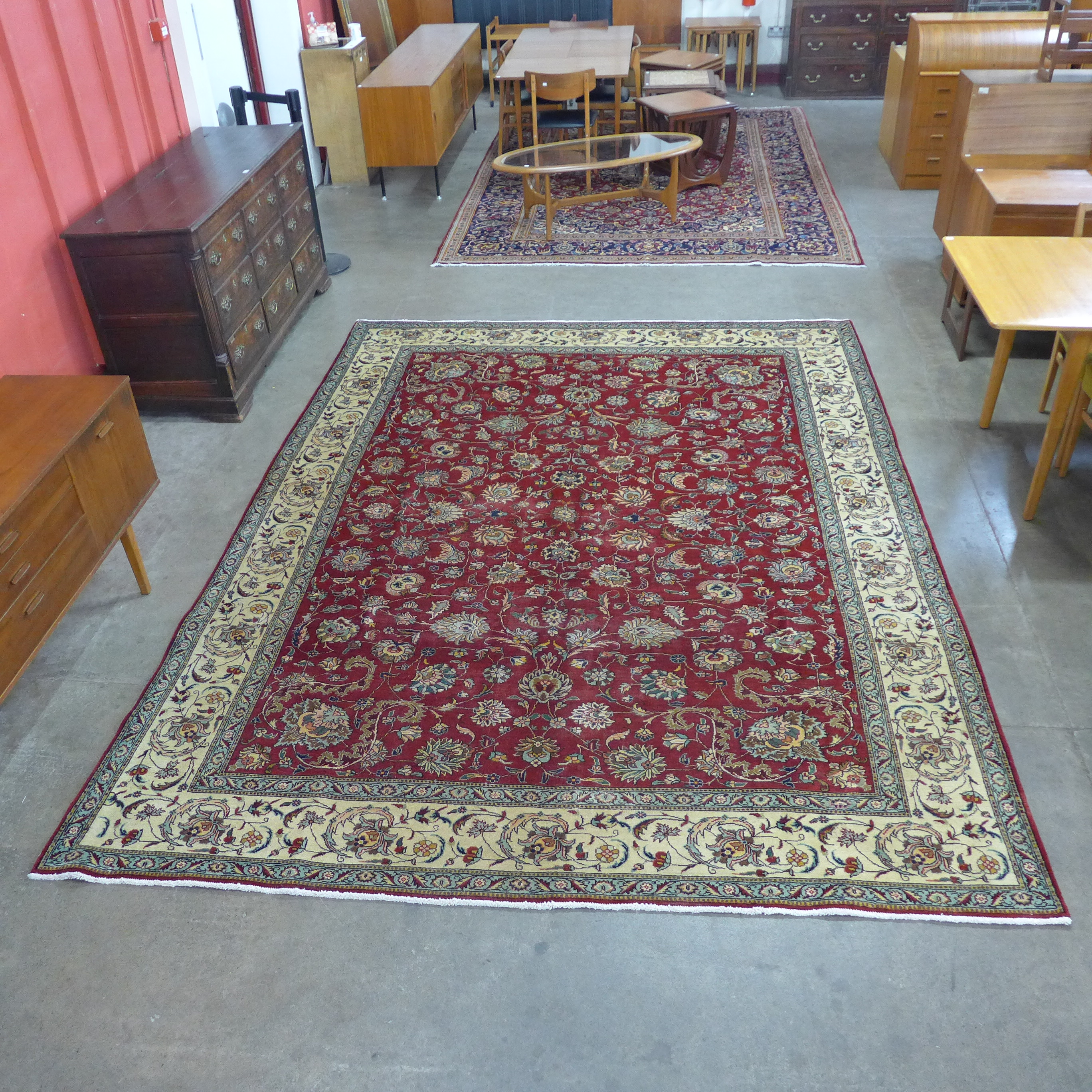 A Persian hand made red ground rug, 335 x 250cms