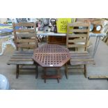 A teak garden table and two chairs