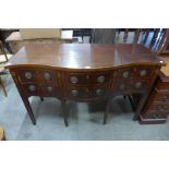 A George III inlaid mahogany serpentine sideboard