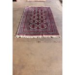 An eastern terracotta ground rug, 240 x 160cms