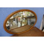 An oak framed oval mirror
