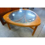 A Nathan teak and glass topped triangular coffee table