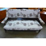 A Victorian Aesthetic Movement mahogany and fabric upholstered settee
