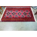 A Persian hand made red ground rug, 204 x 125cms