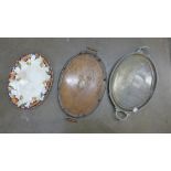 An oak two handled tray, a brass two handled tray and an oval meat plate, crazed and stained **