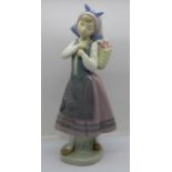 A Lladro Dutch girl with back flower basket, 26cm