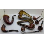 A collection of pipes, two with silver collars