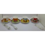 A set of four Wedgwood Clarice Cliff Cafe Noir coffee cups and saucers with spoons, one lacking a