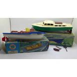 A Penguin clockwork Cabin Cruiser and a Scalex Christine clockwork luxury motor yacht, both boxed