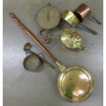 Brass and copper saucepans, a ladle, balance scales and spring scales and a Georgian bed warming pan