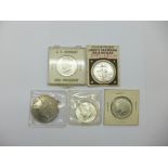 Four USA half-dollar coins, 1935 Liberty Standing and three J.F. Kennedy, and a reproduction one