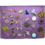 Thirty-two costume brooches