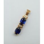 A 9ct gold, two sapphire and four small diamond set pendant, 2.7g, 25mm
