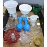 A collection of glass including a green glass goblet, a white cream and sugar, a pair of blue vases,