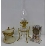 A marble and gilt brass inkwell, a marble clock and a glass and gilt metal oil lamp