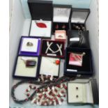 A collection of silver mounted red stone set jewellery, two necklaces, a pair of large silver