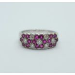 An 18ct white gold, ruby and diamond triple cluster ring, 5g, N