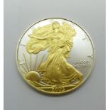 A 2005 USA 1oz. fine silver one dollar coin, layered with 24ct gold