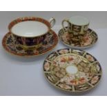 A Royal Crown Derby 1297 pattern cup and saucer, boxed and a Royal Crown Derby 2451 pattern trio