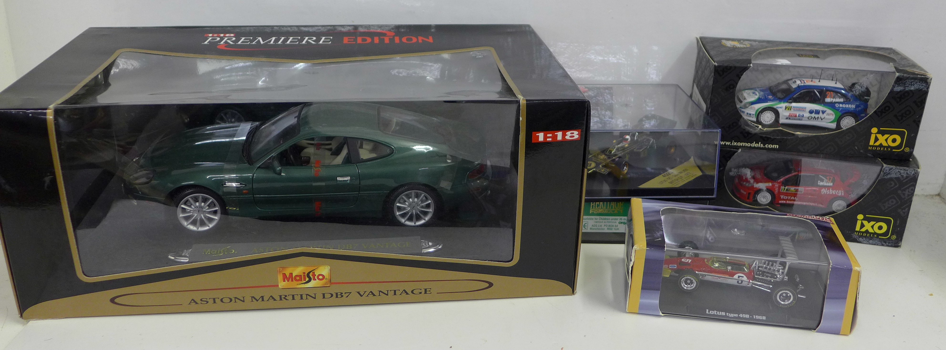 Six model vehicles in boxes, including Maisto, Aston Martin DB7 Vantage and Ixo