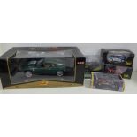 Six model vehicles in boxes, including Maisto, Aston Martin DB7 Vantage and Ixo