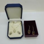 A silver gilt pendant and matching earrings set with diamonds, with a silver chain and a pair of