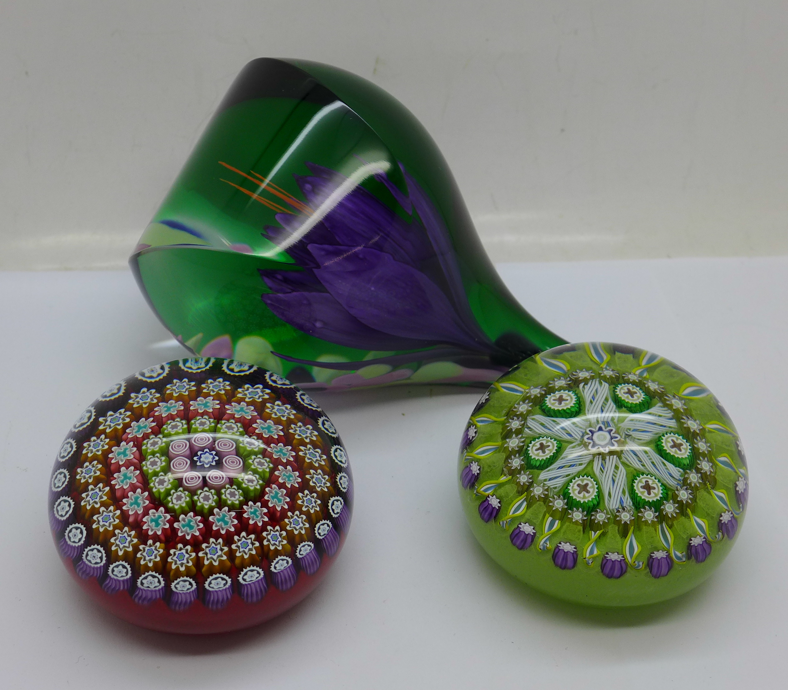 A limited edition Caithness Dewdrop paperweight, boxed, and two Peter McDougall glass paperweights