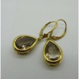 A pair of 9ct gold earrings set with pear shaped stones, 4.2g
