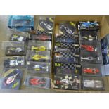A collection of F1 model racing cars, boxed