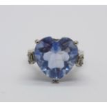 A large silver ring set with a blue heart shaped gemstone, R