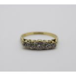 An 18ct gold and platinum set five stone diamond ring, 2.1g, M