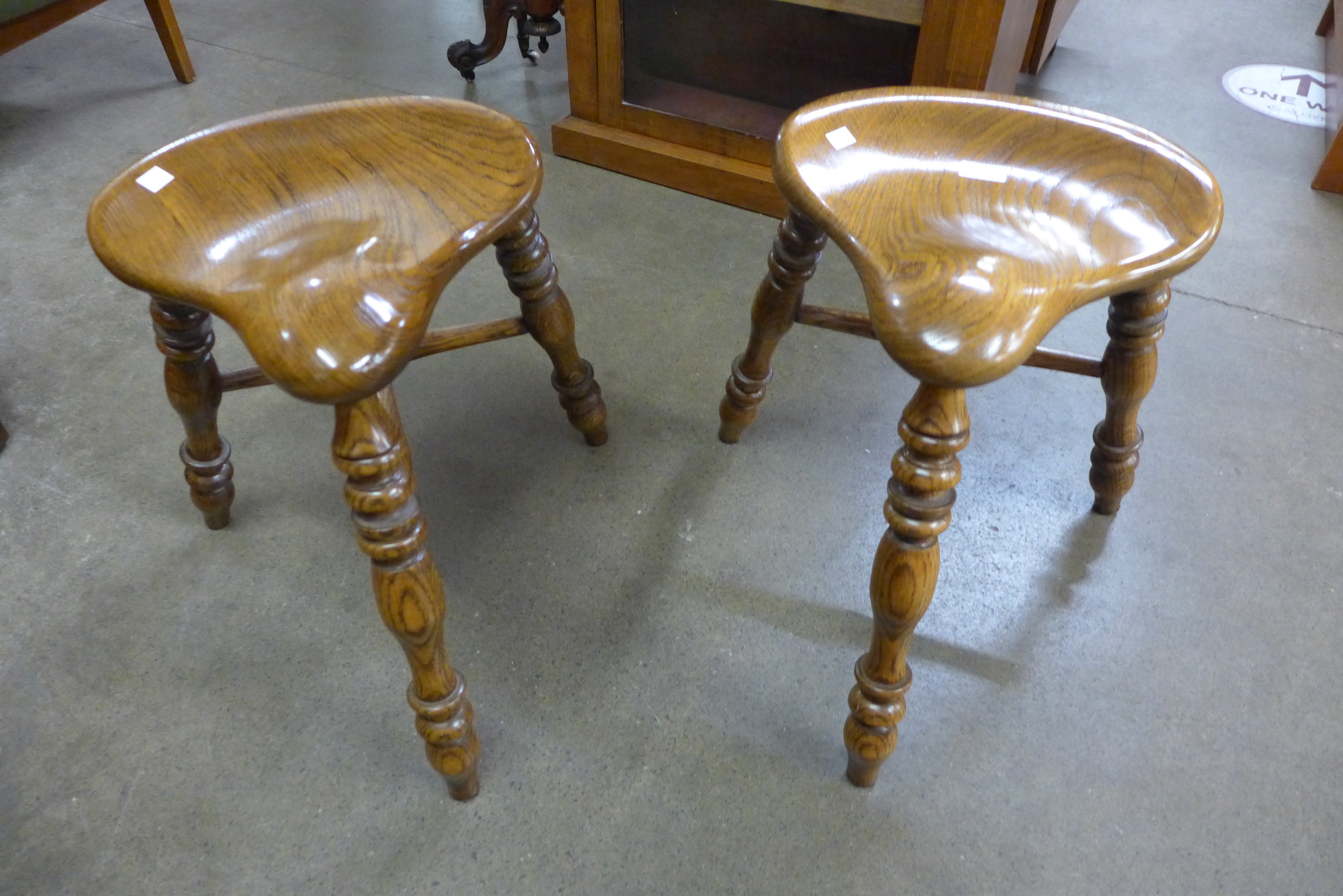 A pair of 18th Century style oak saddle stools