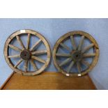 A pair of small oak and iron cart wheels