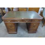 A Victorian style mahogany and green leather topped partners desk