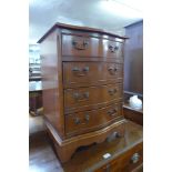 A small mahogany serpentine chest of drawers