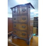 A small walnut serpentine chest of drawers