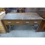 An early 20th Century oak two drawer work bench