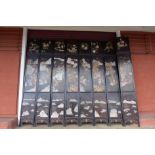A large oriental black chinoiserie lacquered eight fold dressing screen, 274 x 328cms