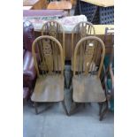 A set of four beech wheelback kitchen chairs