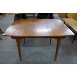 A teak extending dining table