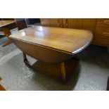 An Ercol Golden Dawn elm drop-leaf coffee table