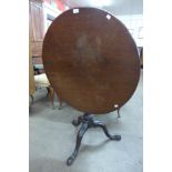 A George IV mahogany circular tilt top tripod tea table