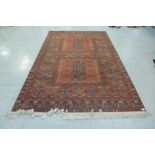 An eastern red ground rug, 305 x 199cms