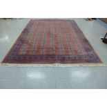 A large terracotta ground rug, 365 x 271cms