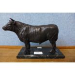 A bronze figure of a bull, on black marble socle, 16cms h