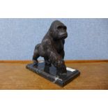 A bronze figure of a gorilla, on black marble socle