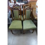 A set of four Edward VII walnut and upholstered dining chairs