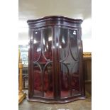 A George III Happlewhite style inlaid mahogany serpentine hanging corner cabinet