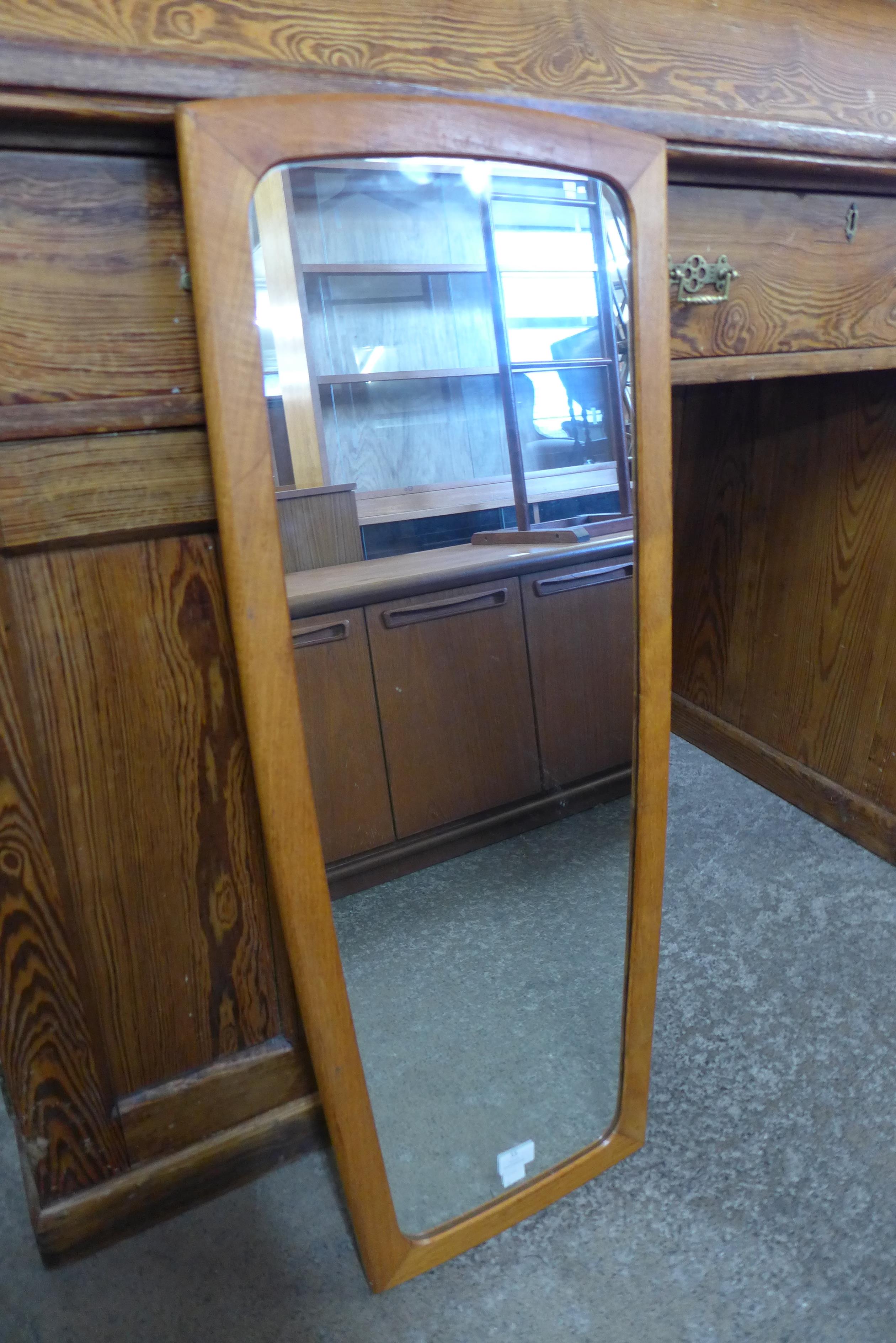 A teak framed mirror