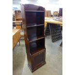 An Art Deco mahogany bookcase/newspaper stand